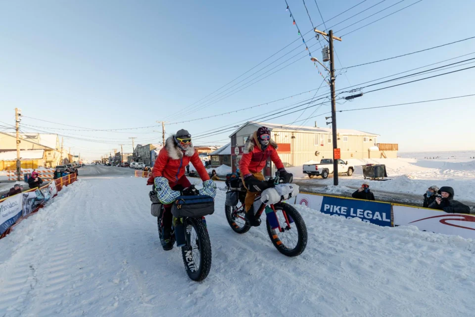 Miron Golfman and Tyson Flaharty approaching the finish in Nome in 2024